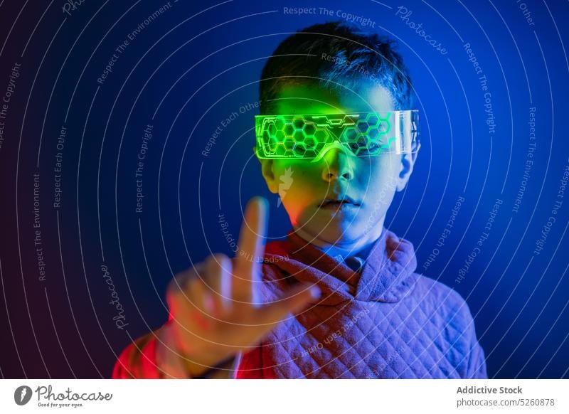 Boy in smart goggles touching invisible screen kid boy touch screen vr futuristic innovation cyberspace scroll swipe tap virtual reality child hi tech