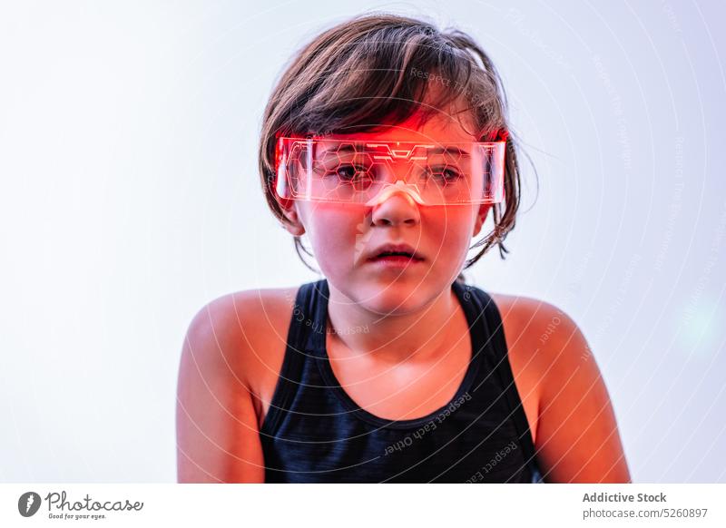 Little girl in futuristic goggles on white background kid vr smart thoughtful cyberspace interactive development future child technology immerse digital