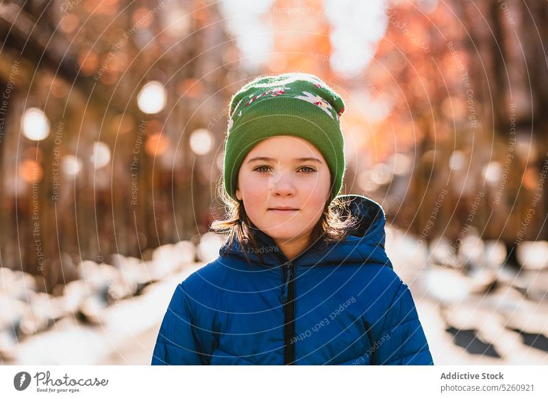 Tranquil girl in outwear in autumn park calm daytime outerwear cold appearance portrait weekend sunlight donostia san sebastian spain child hat coat