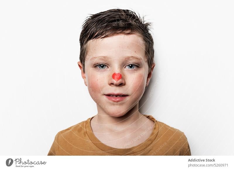 Cute boy with heart on nose cute saint valentine day holiday celebrate love festive portrait paper kid childhood event adorable small symbol romantic tip