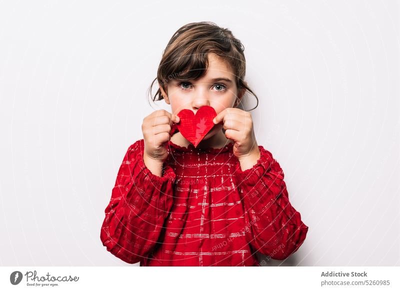 Girl covering mouth with heart girl paper cover mouth love saint valentine day holiday celebrate style cute festive symbol red child bright kid occasion