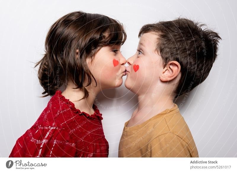 Cute kids kissing each other children love heart celebrate saint valentine day together unexpected holiday affection lip sudden event relationship symbol