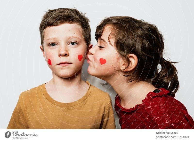 Girl kissing boy on cheek brother sister love children together saint valentine day congratulate celebrate sibling eyes closed relationship tender cute adorable
