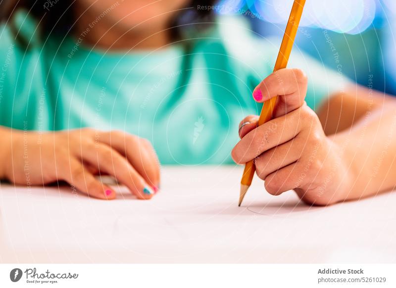 Crop girl drawing picture on table paper sketch creative hobby home imagination design inspiration skill manicure kid child occupation casual pencil elementary