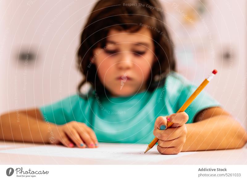 Girl sitting at table and drawing girl home window creative hobby evening child childhood kid pencil sketch cute imagination casual dark hair adorable desk