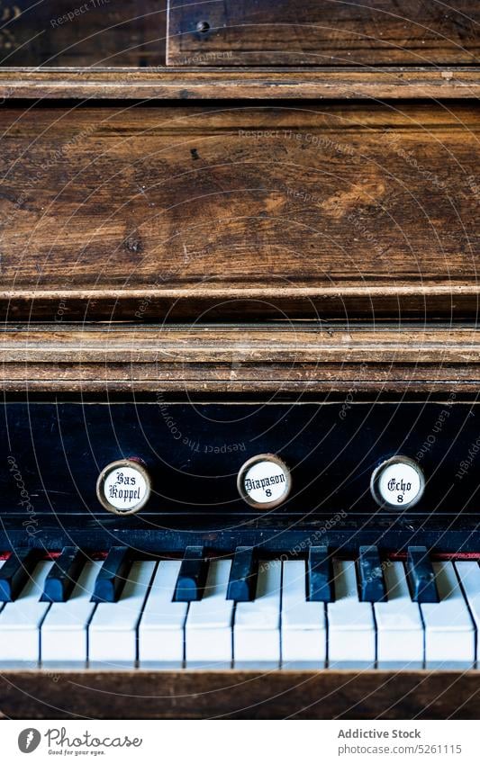 Old rustic vintage wooden piano instrument antique retro old classic key handle aged old fashioned nostalgia shabby music equipment used object art simple