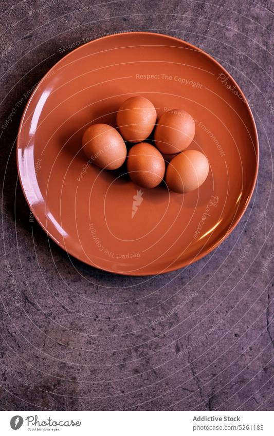 Plate with eggs placed on table raw chicken plate food product ceramic utensil healthy organic uncooked nutrition ingredient natural protein fresh eggshell