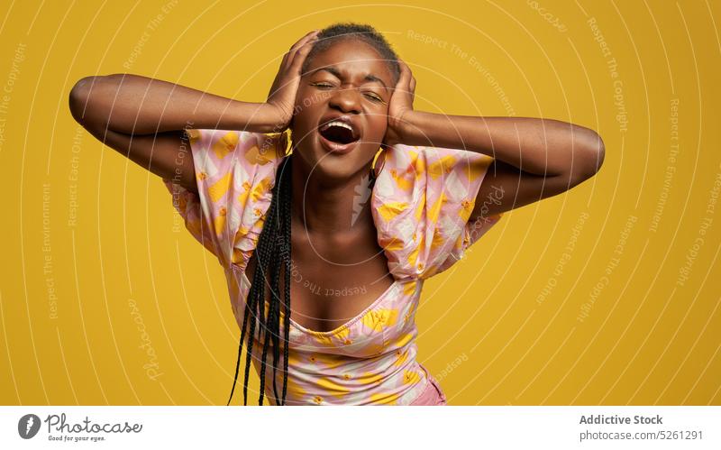 Ethnic woman demonstrating migraine near yellow wall touch head pain eyes closed dress style upset bright young tired colorful african american ethnic black
