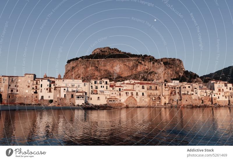 Houses and cliff near sea water house town shore evening building historic architecture sicily italy old aged twilight dusk mountain weather coast district