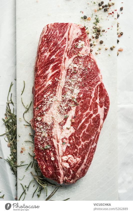 Excellent raw marbled beef chuck eye steak with salt and herbs, top view close up meat beef steak excellent bbq background angus marbling butcher sirloin food