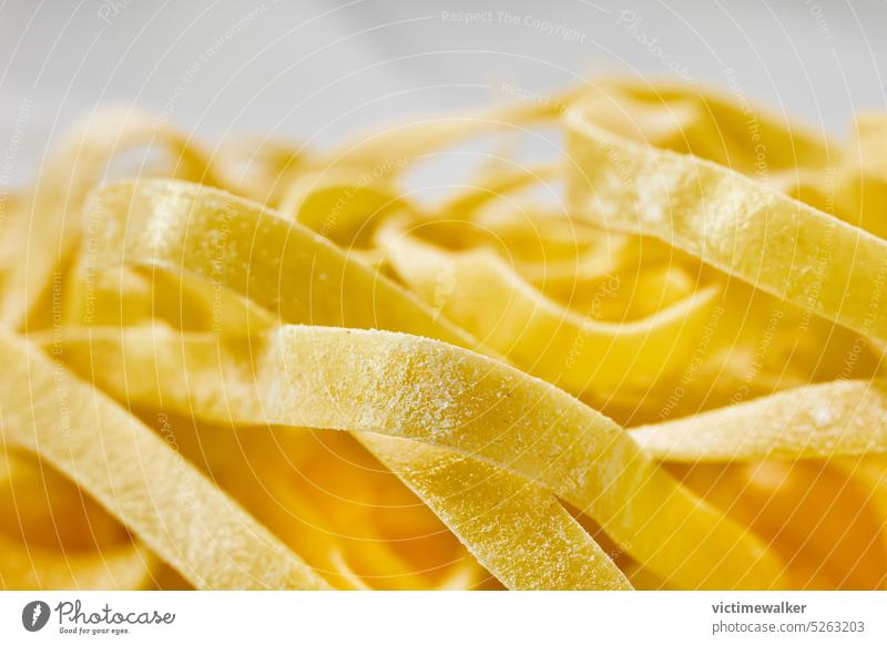 Raw fettuccine pasta detail food yellow cuisine copy space healthy cooking studio shot tagliatelle ingredient background traditional front view closeup