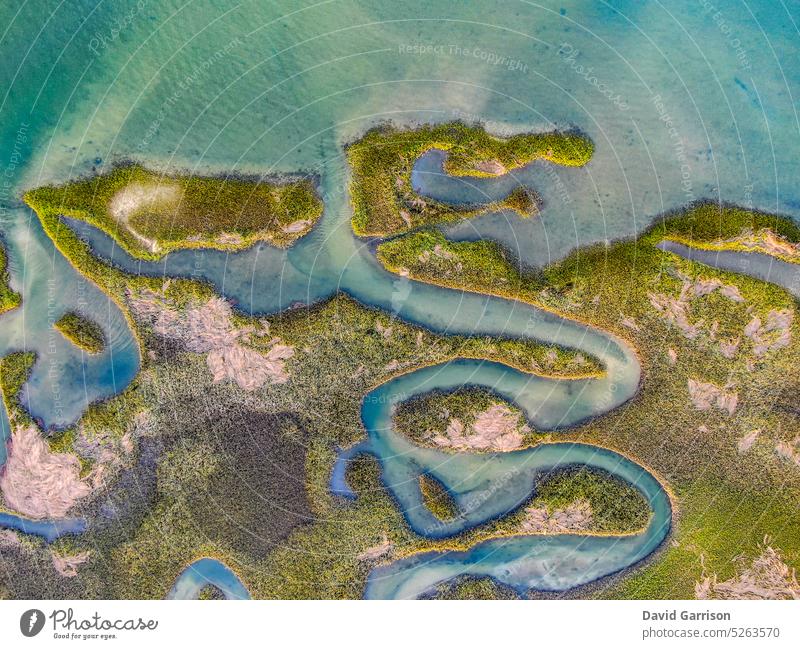 Aerial views from over the marsh of the Atlantic Intracoastal Waterway at Wrightsville Beach, North Carolina. The marsh in the shape of a seahorse. sky