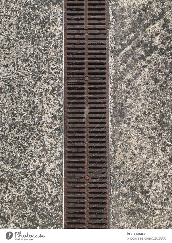 High angle view of storm drain. dry high angle drain system geometric top view plumbing water drainage water removal cement floor urban border sidewalk surface
