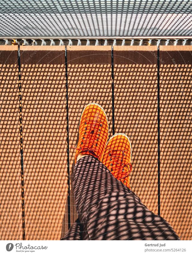 Orange shoes on balcony with shadow pattern Light Visual spectacle Shaft of light Shadow Shadow play shadow cast Pattern Sampling Footwear Balcony balcony rail