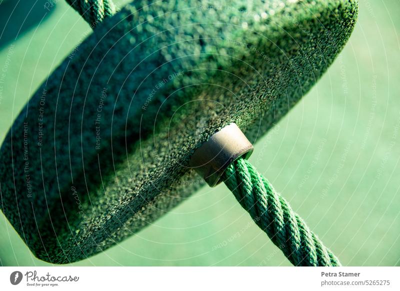 Detail from a climbing aid in green Climbing aid Green detail Rope Metal bushing Leisure and hobbies Sports Lifestyle Colour photo Fitness