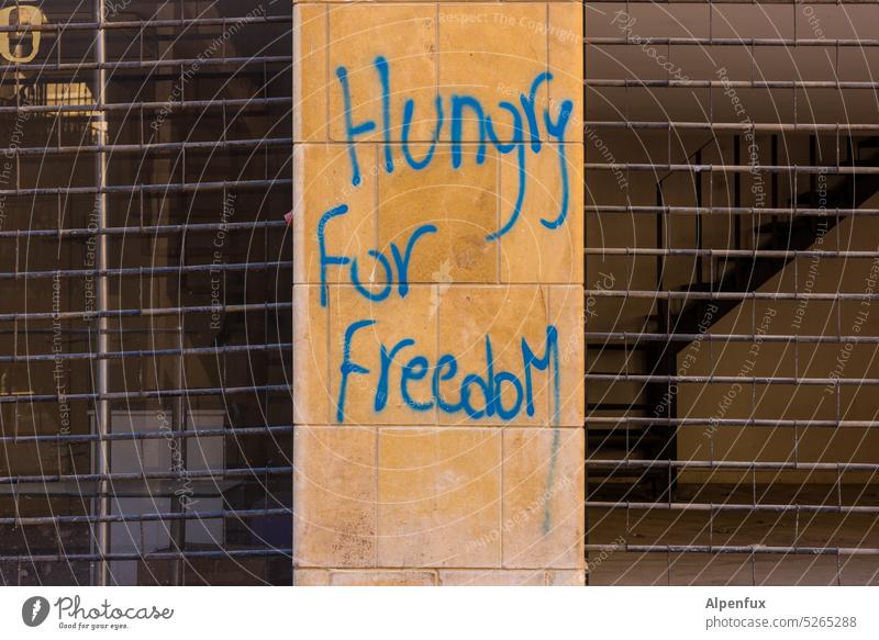 Nobel peace prize nominee | hungry for freedom Peace Wall (barrier) Facade Graffiti Town War Repression Wall (building) Characters Deserted Exterior shot