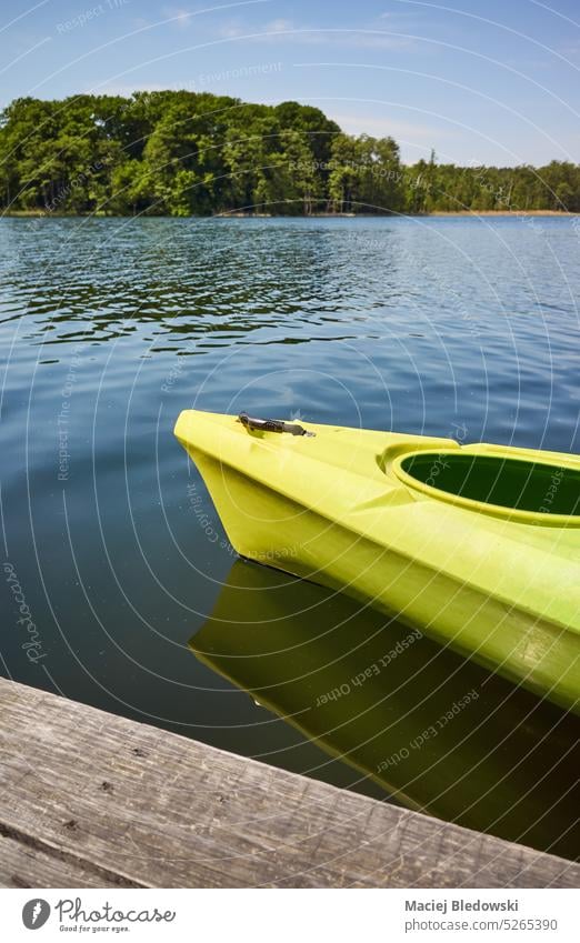 Kayak by a lake pier, selective focus. nature ecotourism kayak water sport landscape outdoors sea canoe adventure forest sky day sunny summer leisure river
