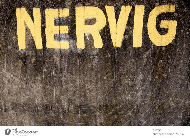 NERVIG, yellow inscription on dirty concrete wall Bothersome Exasperated Frustration Annoyance Aggravation tax return Transport Noise Construction site Emotions