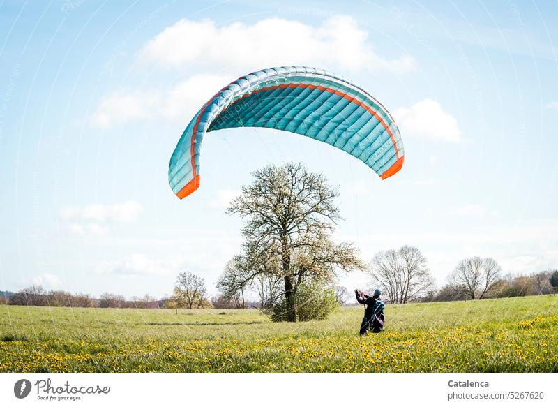 Paraglider training on the ground with his glider; groundhandling Nature Spring Landscape flora paraglide workout Ground Practice Floor training