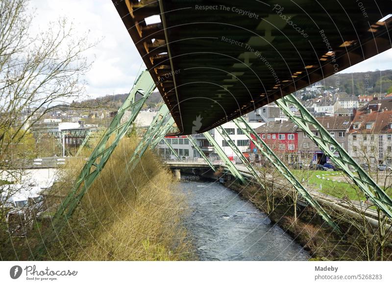 Steel girders of the track of the Wuppertal suspension railroad over the river Wupper in springtime sunshine in the city center of Wuppertal in the Bergisches Land region of North Rhine-Westphalia, Germany