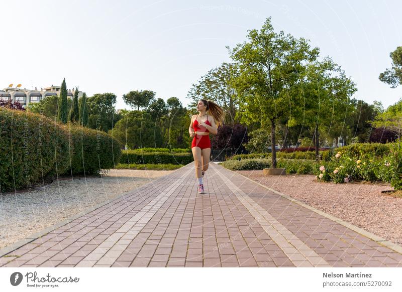 An Energetic Young Woman Running in the Park running Jogging Fitness Exercise Active lifestyle Health and wellness Outdoor activity Nature Athletic Endurance