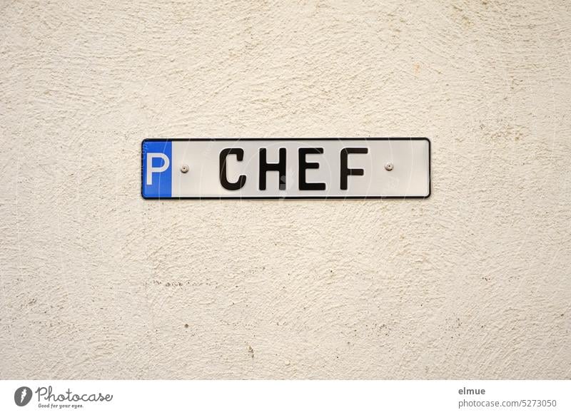Metal sign with P CHEF on a bright wall / parking for the boss Parking lot Chief parking metal plate Special regulation Special treatment Blog Reserved