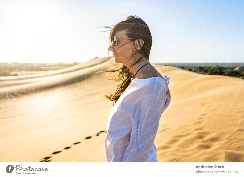 Woman in white clothes standing in desert woman traveler sand blue sky cloudless calm idyllic peaceful heat female frontera dry buenos aires argentina lady wind