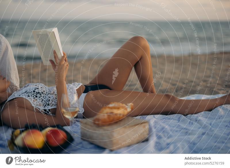 Girlfriends reading books during picnic on beach women date couple lesbian sundown sea romantic female young girlfriend together love holiday lgbt ocean sunset