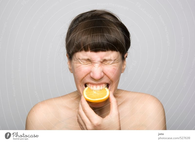 Woman bites into sour orange Fruit Orange Orange slice Slice of lemon Nutrition Organic produce Vegetarian diet Diet Healthy Healthy Eating Life Well-being