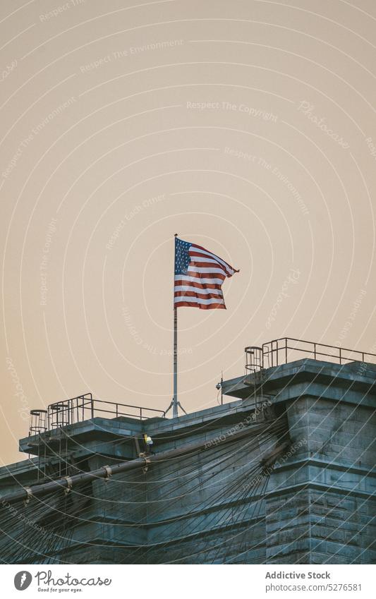 American flag on roof of building american wave symbol patriot sky national stars and stripes overcast independence day democracy cloudy culture usa freedom