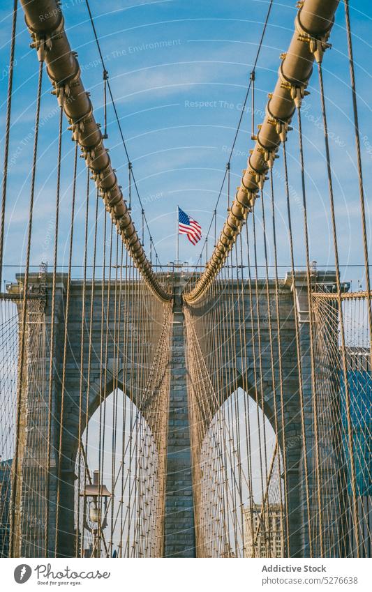 Famous suspension bridge with American flag on top american sunny day city national sunlight culture trip brooklyn bridge new york usa united states
