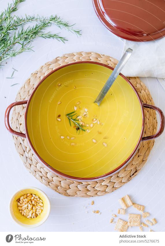 Pumpkin cream soup in saucepan pumpkin food dish lunch serve delicious puree cuisine meal seed ingredient kitchen table tasty culinary appetizing healthy fresh