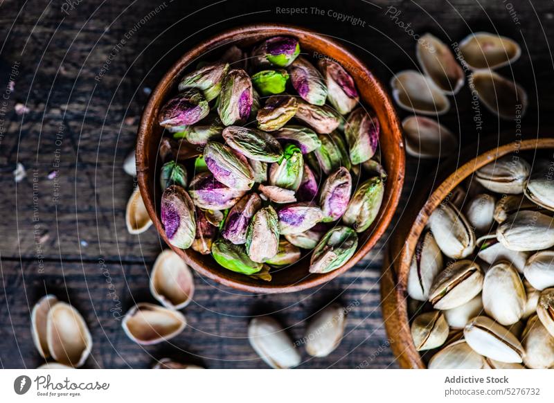 Raw organic pistachio nuts in the bowl assortment background concept concrete cooking dark diet eat eating food green healthy keto ketogenic meal nutshell