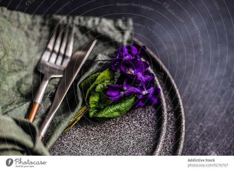 Spring table setting with viola flower background blue ceramic concrete cutlery dinner dinnerware easter eat eating festive floral green holiday meal napkin