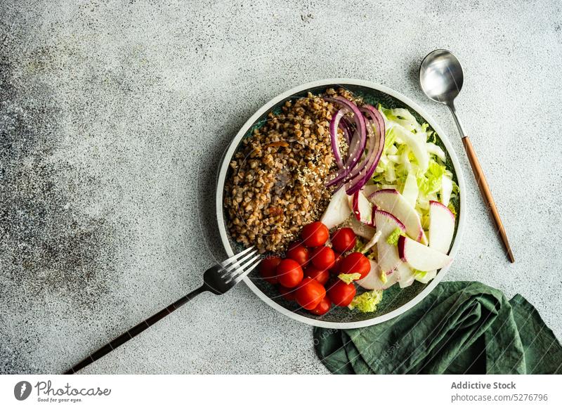 Bowl with buckwheat salad background bowl cabbage cherry tomato concrete cutlery diet eating food fresh gourmet grey healthy keto ketogenic lettuce lose weight