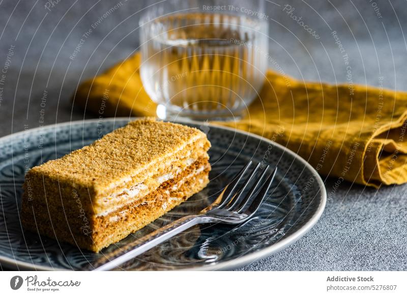Honey cake on the plate honey bake biscuit ceramic plate cream dessert eat food fork gourmet meal sugar pastry served slice sweet table tasty glass topping
