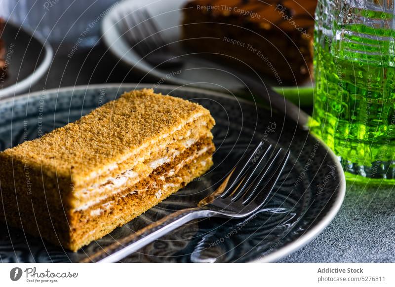 Honey cake on the plate honey bake biscuit ceramic plate cream dessert eat food fork gourmet meal sugar pastry served slice sweet table tasty glass topping