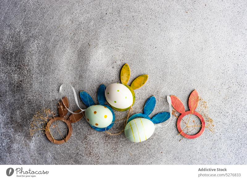 Flat lay with eggs for Easter holiday bunny color concept concrete dots ears easter festive flat lay floral flower handmade homemade multicolor season spring