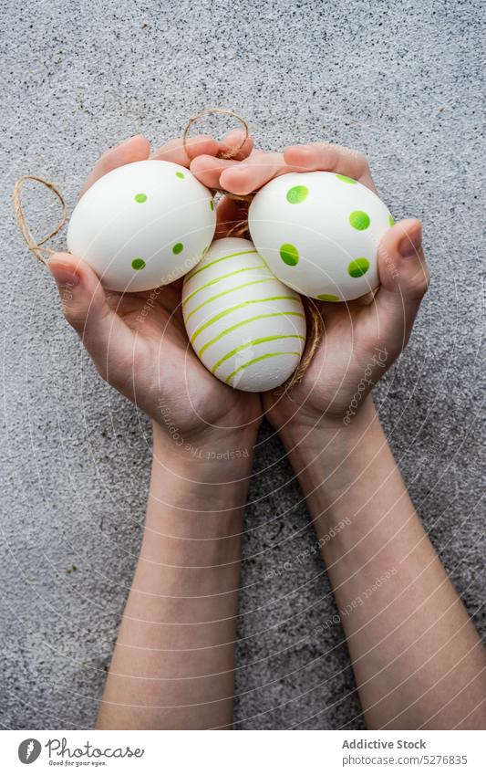 Kids hands full with eggs child colored concrete dots easter festive green handmade hold holiday kid minimalism natural season spring still life stripped decor