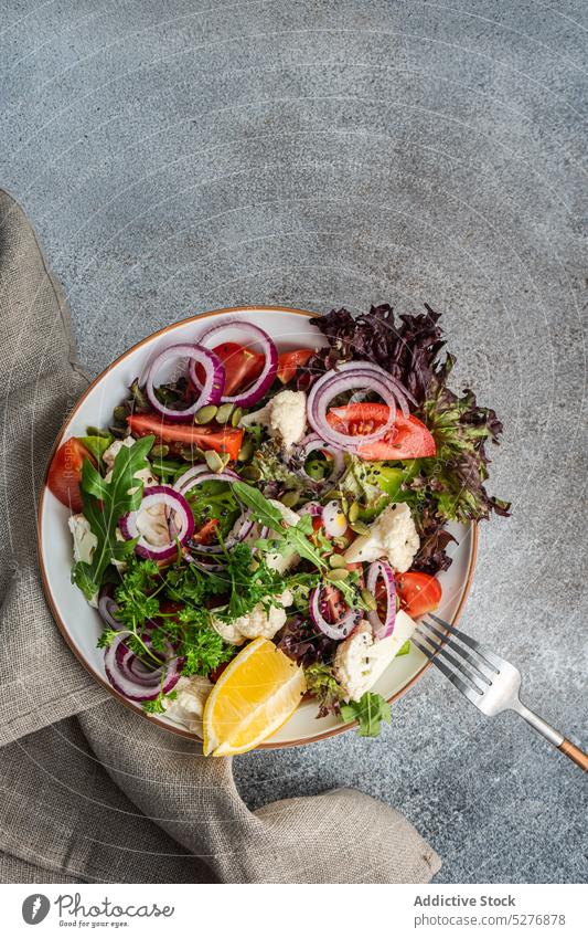 Healthy salad in the bowl background concept concrete copy space cutlery dinner dinnerware food fresh healthy herb ingredient napkin oil organic plate raw