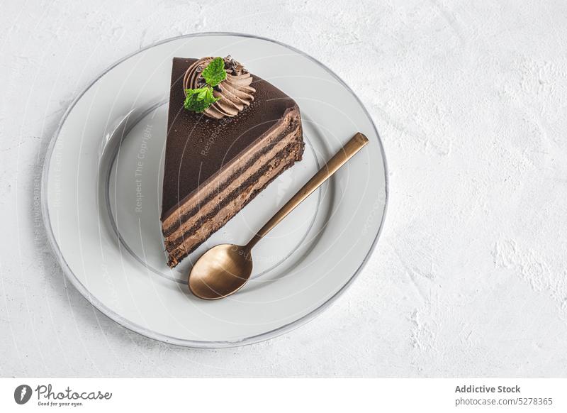 Served delicious chocolate cake with topping food dessert serve piece cream baked confectionery sweet plate spoon treat yummy pastry ceramic tasty portion