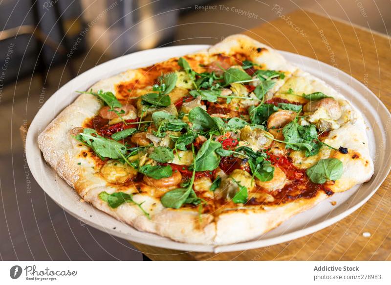 Pizza with basil on a wooden table pizza vegetable italian tomato food fresh traditional sauce cheese dinner homemade copy space rustic herb mediterranean