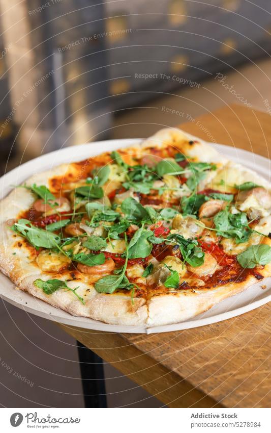 Pizza with basil on a wooden table pizza vegetable italian tomato food fresh traditional sauce cheese dinner homemade copy space rustic herb mediterranean