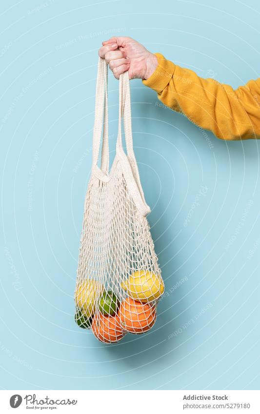 Cropped anonymous person with bag of fruits woman senior grocery food portrait ripe female joy sweater casual retire vibrant carefree pensioner organic net aged