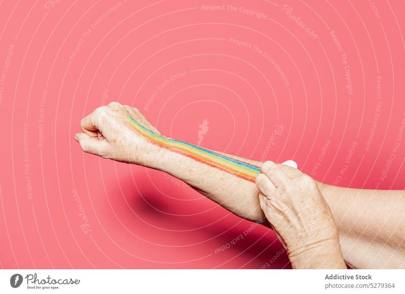 Crop person drawing rainbow on hand show concept creative colorful equal art lgbt demonstrate symbol studio bright pigment arm vivid paint vibrant accept