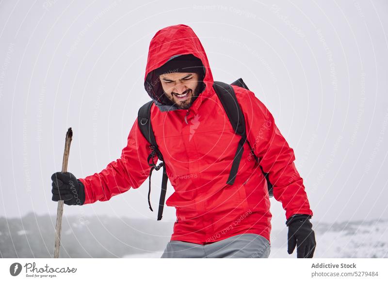 Man in outerwear walking with stick on snowy terrain man hiker traveler wanderlust weather cold tourism male tourist explore trekking rucksack santa isabel