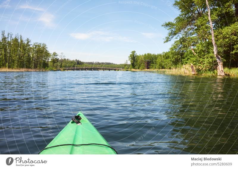 Picture of a kayak bow on lake water, selective focus. nature ecotourism sport landscape outdoors sea canoe adventure sky day sunny summer leisure river