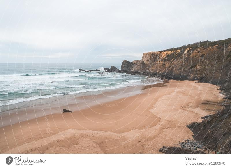 Panorama of the beautiful Praia da Amalia beach at sunset on the Fisherman Trail, which lines the Atlantic coast in the west of Portugal. A well-known tourist destination