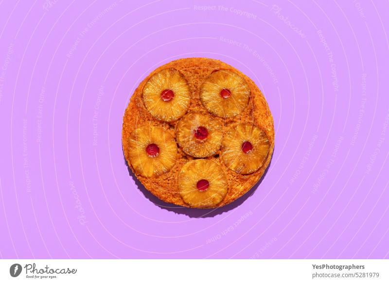 Pineapple cake top view, isolated on a purple background above ananas baked bakery bright caramel color cuisine cut out delicious dessert dish flat lay food