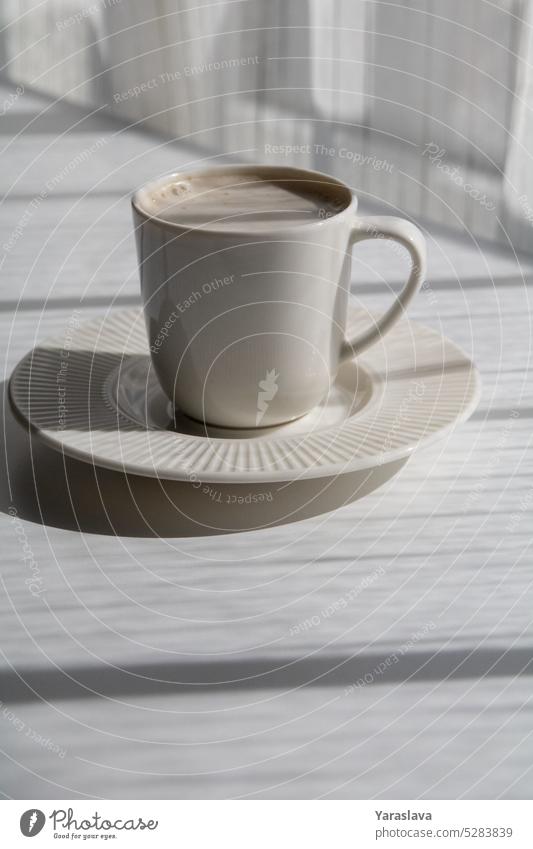 photo white cup with coffee on a saucer cafe mug beverage drink table aroma bean black caffeine morning background hot drink sunlight food lifestyle roasted